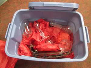 Covered tote filled with glassware and home decor