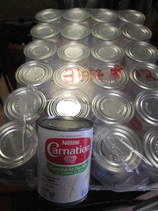 24 Cams of Carnation milk dated 2-24