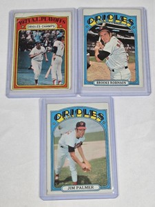 Lot of 3 Vintage Topps 1972 Baseball Cards Featuring Brooks Robinson and Jim Palmer Including 1971 Orioles Champions Card.