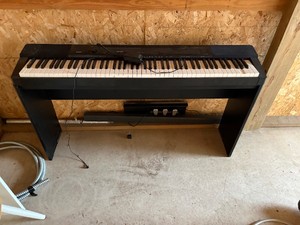 Piano with foot pedals and base