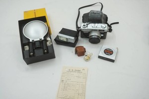 Cannon camera in with 2 flash and an old receipt
