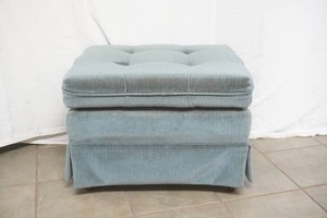 blue upholstered ottoman on wheels