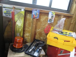 Small plastic toolbox with variety of hand tools and accessories, hose saver, car freshener, auto lockout tool kit and 12v automotive top safety flasher