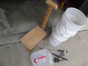Ice fishing poles, buckets, water jug and wooden stool