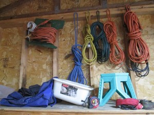 Variety of assorted length and gauge extension cords, ratchet straps, collapsible stool and more