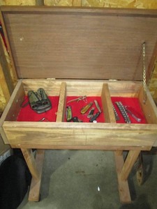 Rolling wood display case with assorted pocket knives, binoculars and more