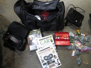 Duffle bag with vintage car phone, eyewitness books, fire crackers and more