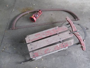 Vintage snow sled, bow saw and lantern
