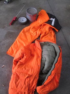 Vintage metal minnow bucket, blaze orange insulated jacket and bibs plus misc items shown