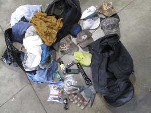 Collection of assorted style baseball hats, mens clothing, duffle bags, hand tools and more