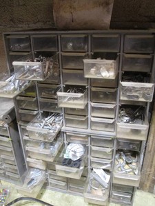 Multi-drawer organizer full of assorted hardware, impact screwdriver bits and extensions