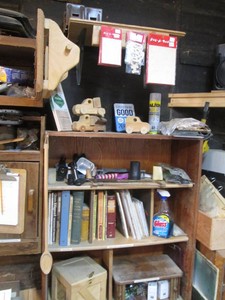 Large variety of woodworking crafts, firearm books, mini grease guns inserts, torches and other materials shown