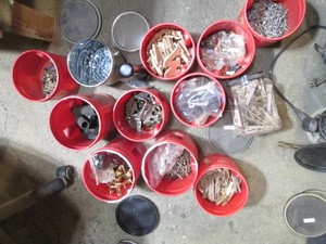 Multiple coffee containers with cabinet hardware, nails, screws, clothes pins and more