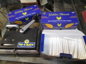 Top-O-Matic manually operated cigarette rolling machine with tubes