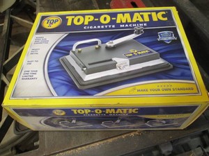 Top-O-Matic manually operated cigarette rolling machine in original box