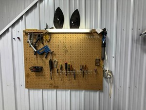 Everything on Pegboard - Fuel Nozzle, Screwdrivers, Light, Stapler