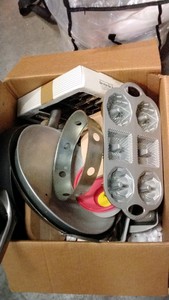 open box of kitchen pots, pans, baking sheets