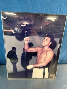 Vintage color photograph of boxing legend Muhammad Ali working out with a speed bag in a gym