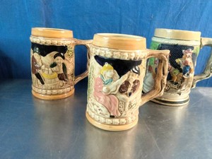 Three vintage, German-style ceramic beer steins