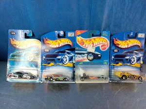 Four unopened 164 scale diecast vehicles from the Hot Wheels Racing series