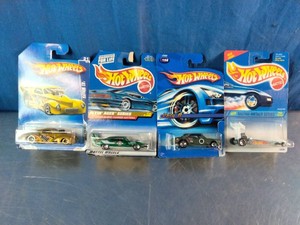 Four vintage, factory-sealed Hot Wheels die-cast toy cars
