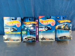 Four packaged vintage Hot Wheels die-cast dragsters and custom cars.