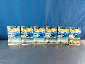 Six unopened 1994 Hot Wheels Race Team Series diecast cars in blue blister packages