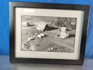 Vintage, black-and-white aerial photograph of a rural homestead or farmstead
