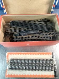 Large collection of black plastic and metal model train tracks,