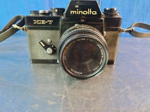 Vintage Minolta XE-7 35mm SLR film camera equipped with a Rokkor prime lens