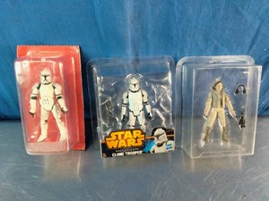 three packaged Star Wars 3.75-inch action figures, including two Clone Troopers and one character in scout or pilot gear.