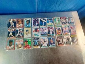 Collection of assorted vintage baseball trading cards laid out in a protective sheet, including players like Joe Carter, Dave Winfield, and various 1980s era MLB players.