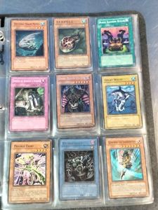 A collection of vintage Yu-Gi-Oh trading cards from early sets.