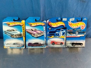 Four carded Hot Wheels die-cast vehicles, featuring two custom Cadillacs and two classic sportmuscle cars.