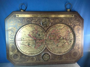 Vintage mid-century modern wall hanging made of carved wood and brass, appearing to be a 1964 Mappe of the World produced by Masketeers Inc.