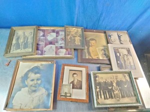 An assortment of framed vintage and antique photographic portraits