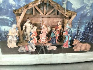 A packaged 13-piece porcelain nativity set with a wooden stable by Gerson Internationa