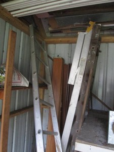 Aluminum ladders, wood ladder and other supplies shown