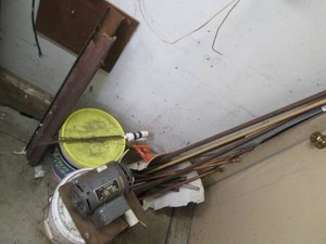 Variety of scrap copper piping, angle iron and assorted supplies shown