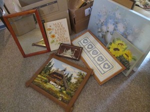 Collection of assorted style wall art from paintings on canvas to Yarnwork to mirror.
