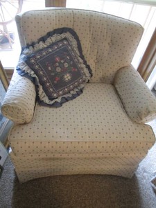 Padded and upholstered relaxing chair with accent pillow