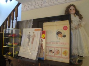 Vintage 27in Porcelain doll, Vintage Paper Dolls and Glass display box containing a variety of hand painted floral decor aporox 9x11in