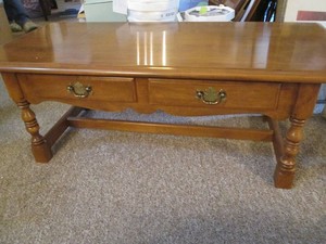 Vintage wood coffee table with detailed carvings, storage drawers abd antique brass tone hardware approx 48x24x18in