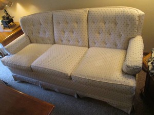 Padded and upholstered 3-cushion couch
