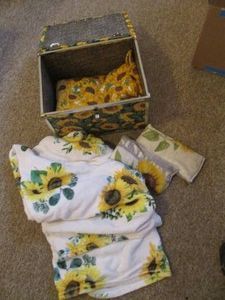 Sunflower themed keepsake storage box with Sunflower themed throw blankets and neck wraps.