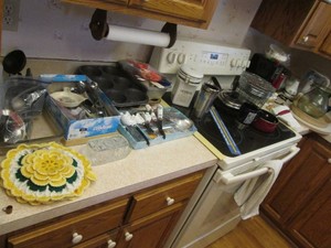 4-cup coffee maker, pizza and pie stones, toaster, hand mixer, coffee mill, seasoning shakers, cookware, bakeware, flatware with drawer organizer tray and assorted kitchen utensils