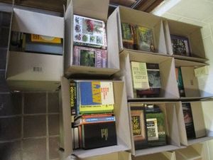 9 Boxes of hard and soft cover books