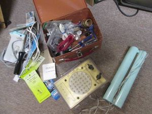 Transistor radio, soldering and other tools in a metal case