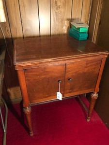 Domestic sewing machine in cabinet with accessories