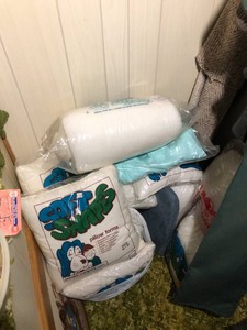 Pillow forms, batting, material all on floor in closet